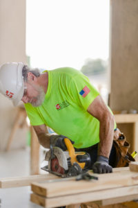 Clancy & Theys general contractor construction worker using a saw