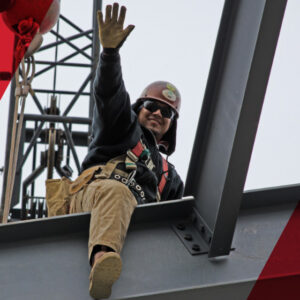 Employee with safety gear waving