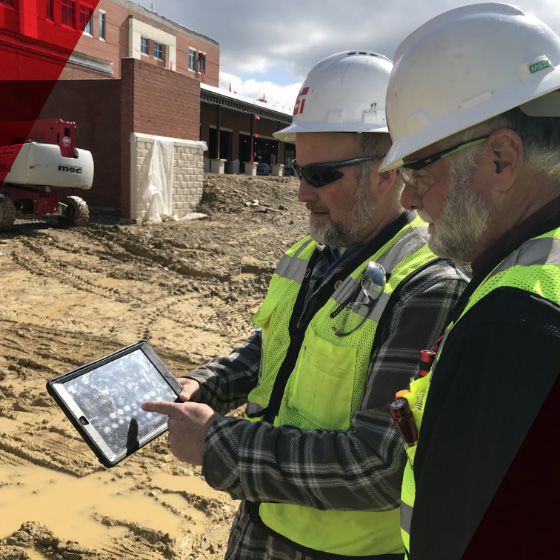 Construction managers looking at a tablet