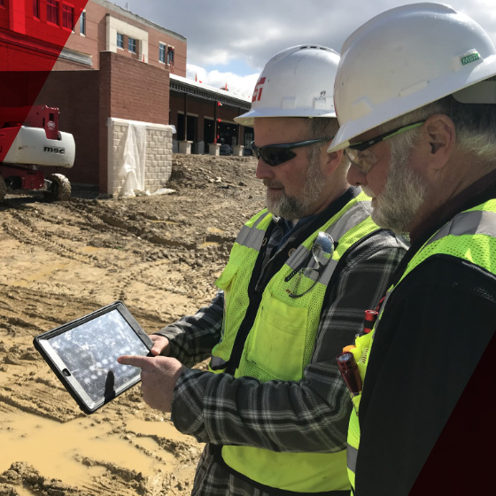 Construction managers looking at a tablet