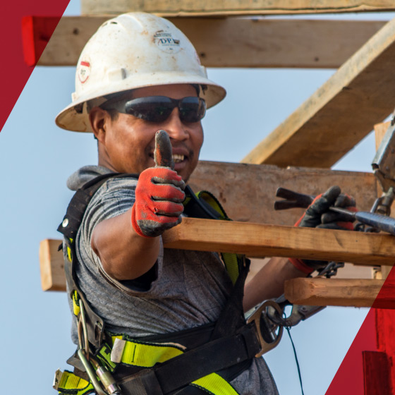 Construction worker giving positive hand signal.